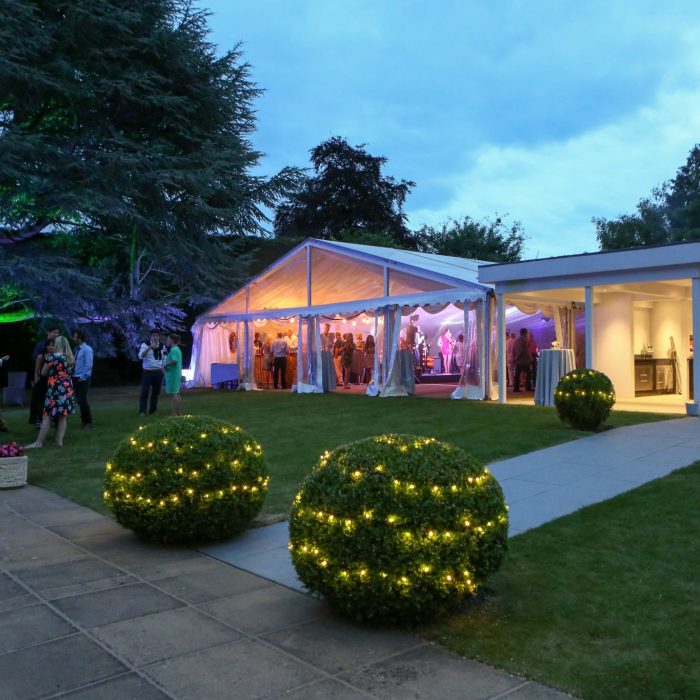 Marquee joined to house with garden lighting
