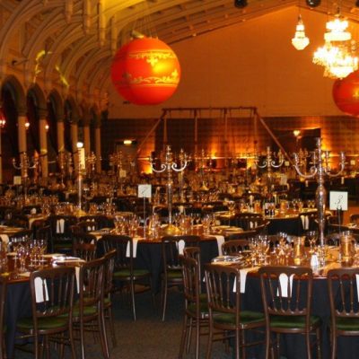 The passenger shed venue transformed for a party with Brunel wall linings dining tables and overhead dressing