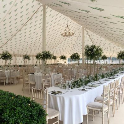 A marquee wall lining with a fern leaf printed design on the linings over the dining room