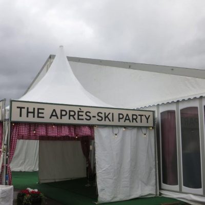 A marquee entrance to an Apres Ski party with Gingham curtains