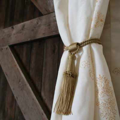 A barn door with a Jasmine wall lining and gold tassle