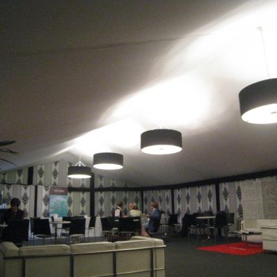 A corporate event marquee with Rococo marquee wall linings and black lighting overhead