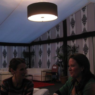 A marquee with Rococo marquee linings on the wall, white linings in the ceiling and black pendant light overhead
