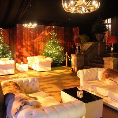 Wood plank wall linings used around the marquee walls at a party with Alpine themed props furniture and lighting