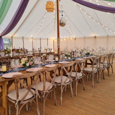 Botanical marquee wall linings in the background of a marquee with marquee company-supplied ceiling overlays in complimentary colours